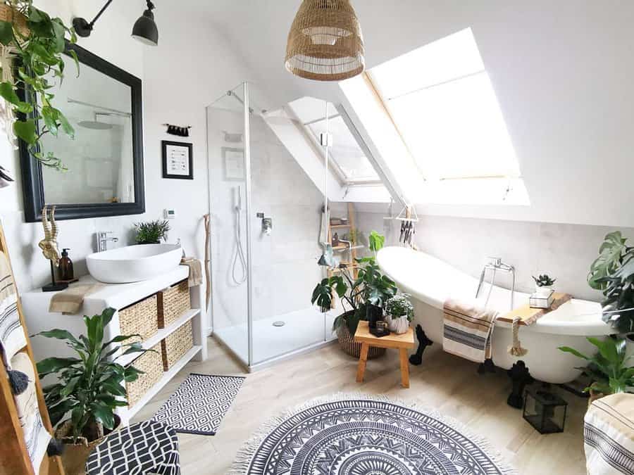 Green oasis bathroom with patterned rugs and white tub