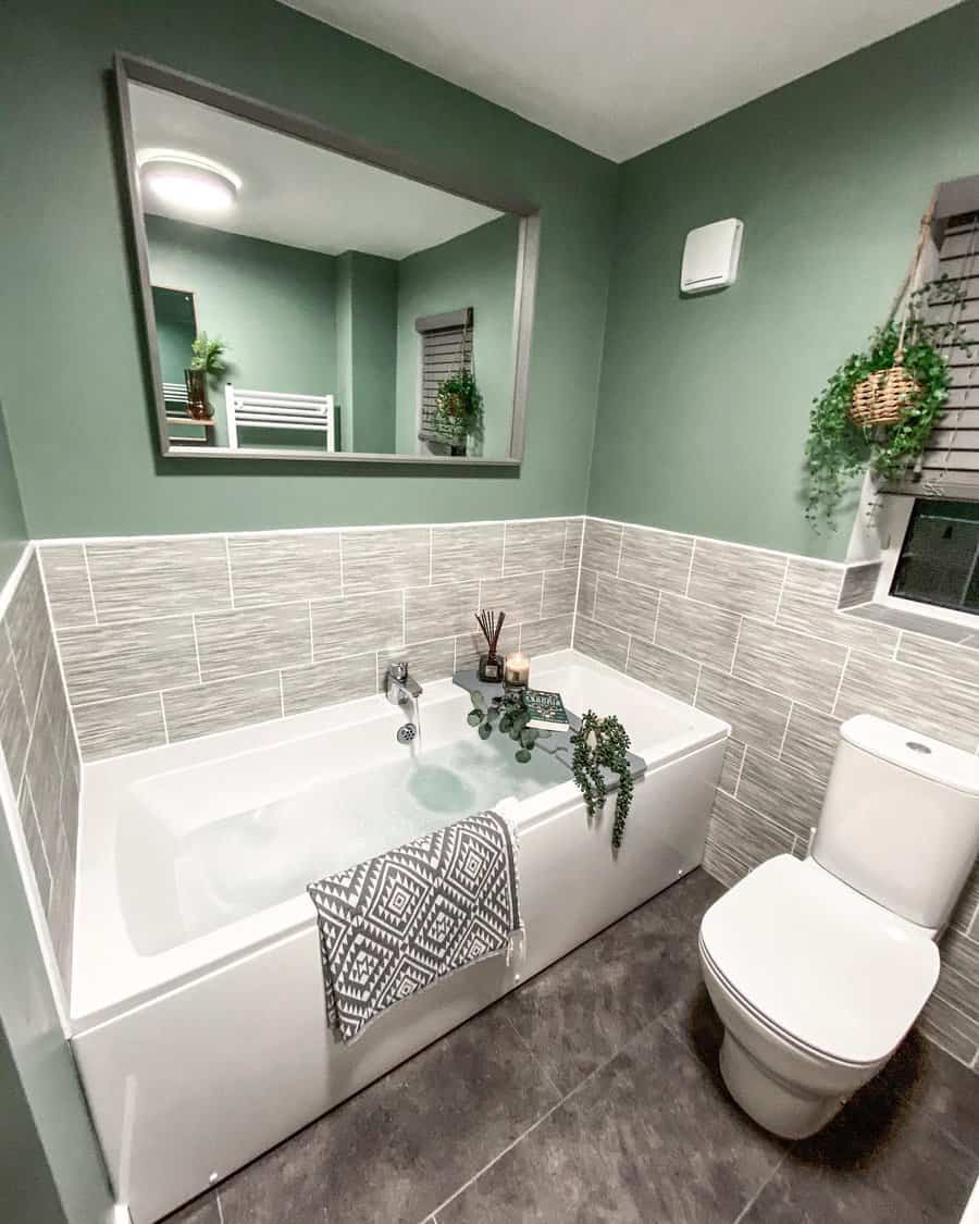 Serene bathroom with green walls and white fixtures