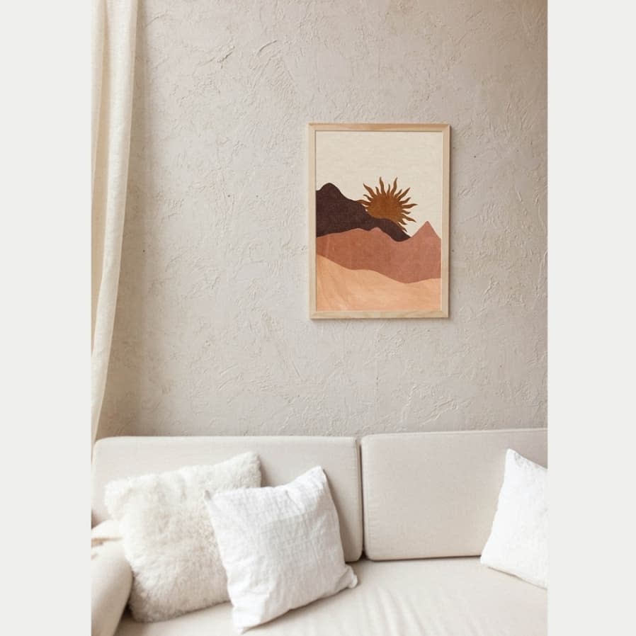 Abstract mountain art above a sofa with plush pillows