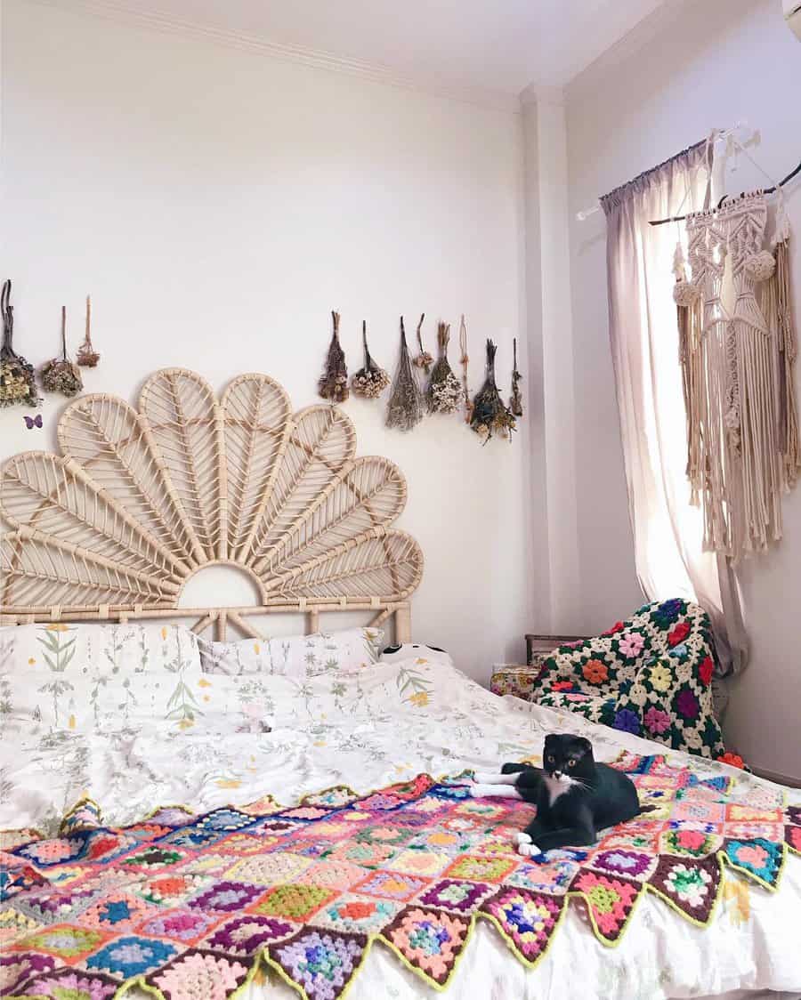 Whimsical boho bedroom with peacock headboard and cat