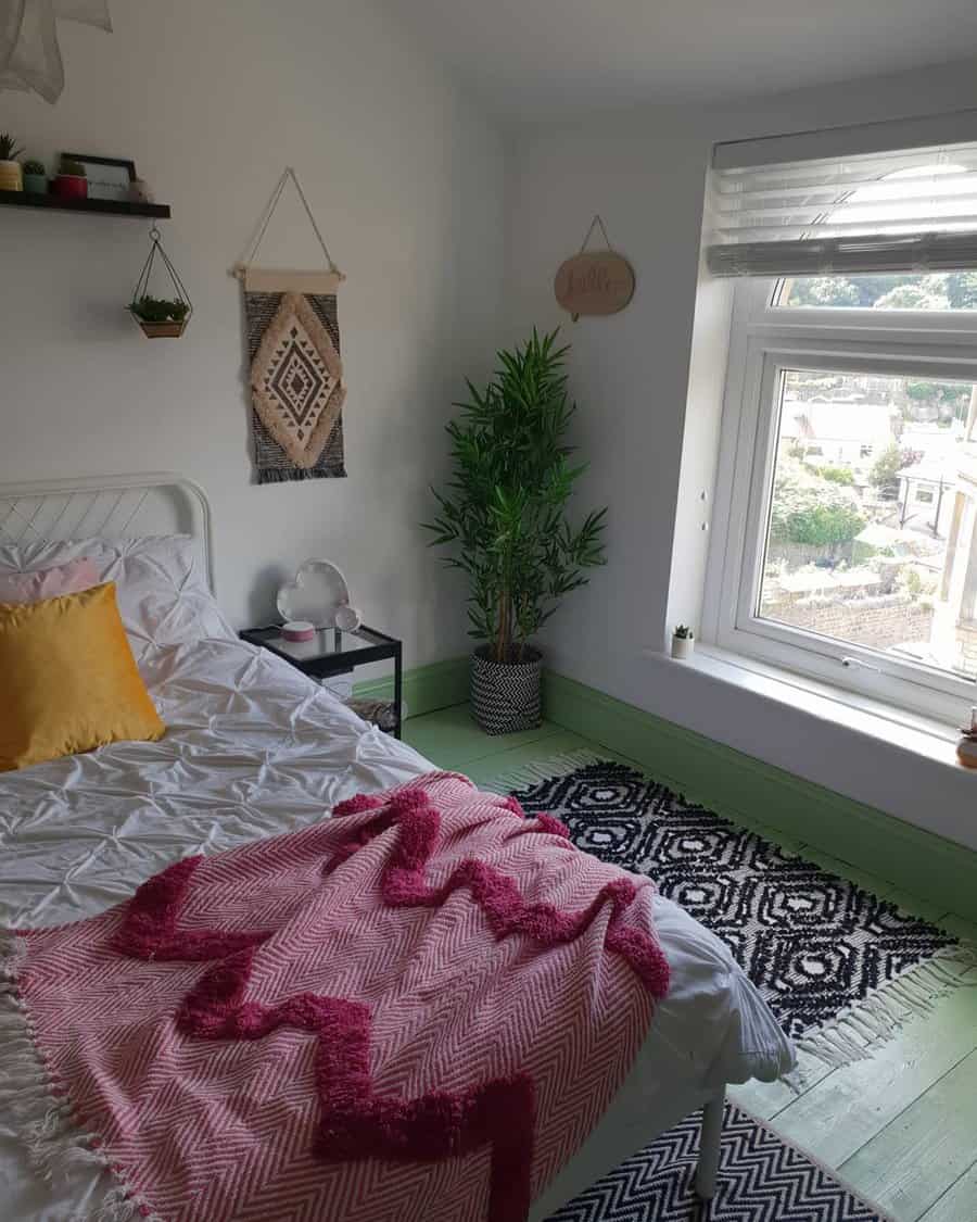 Eclectic bedroom with green accents and wall decor