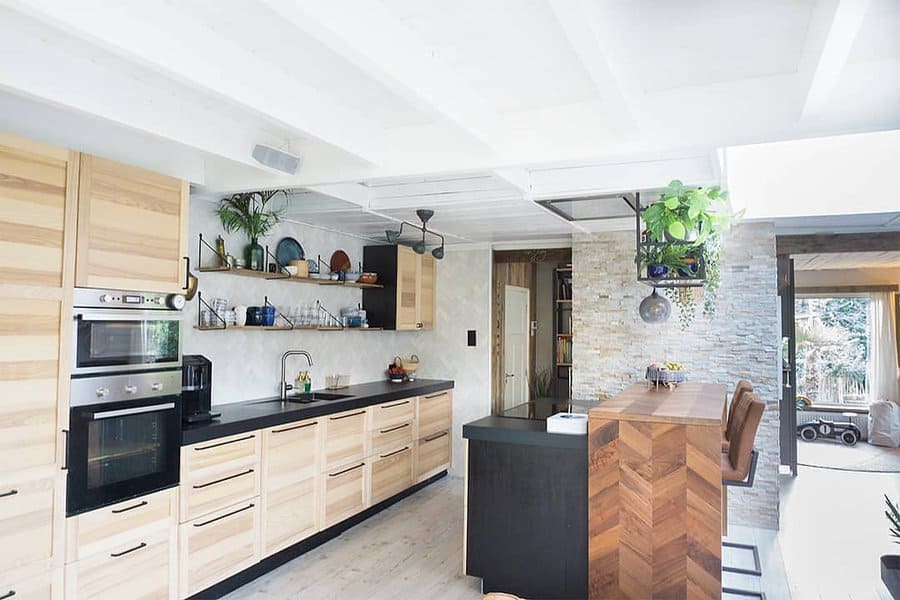 Wooden kitchen with island and hanging green plants