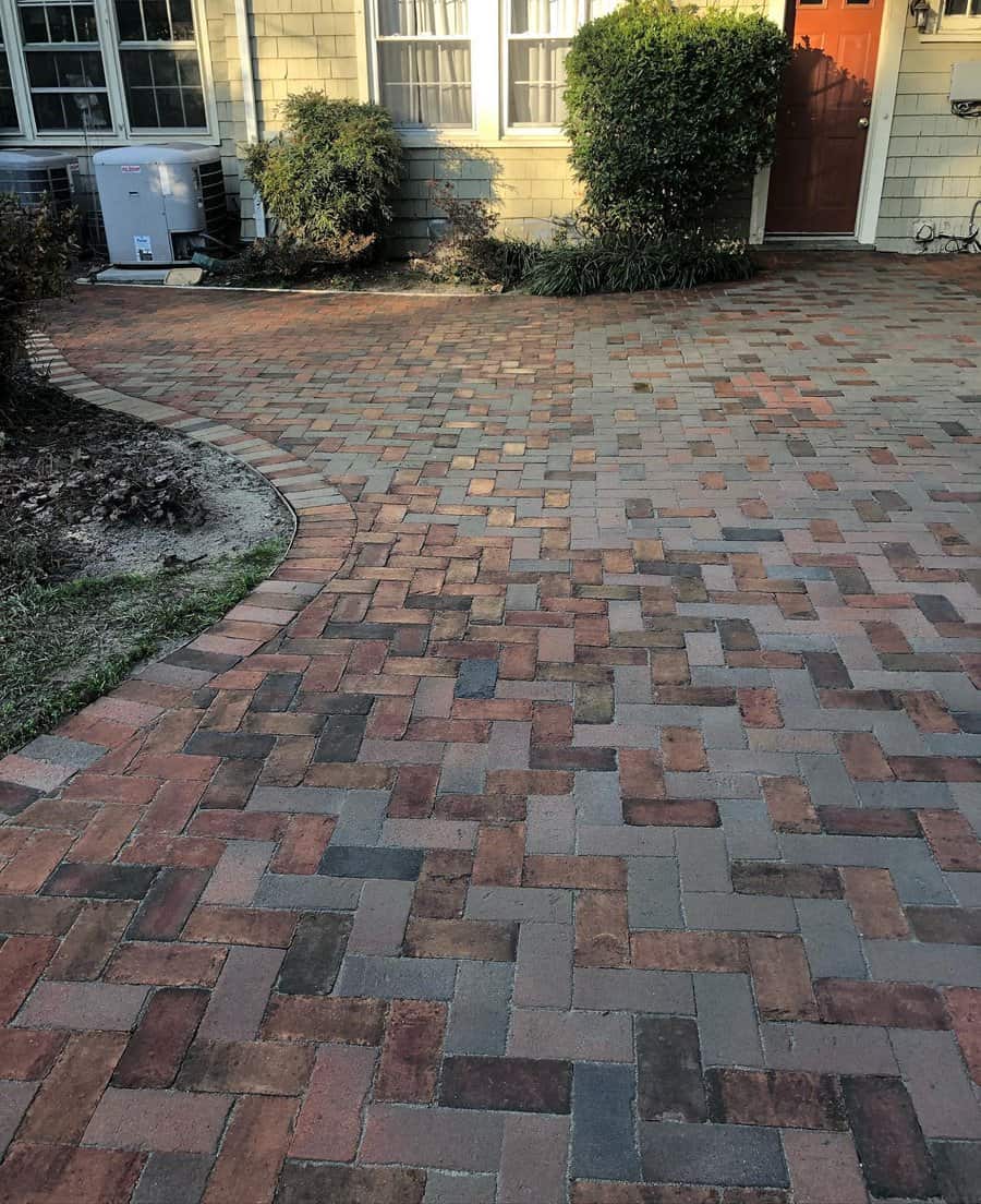 Brick patio with varied hues leading to house door