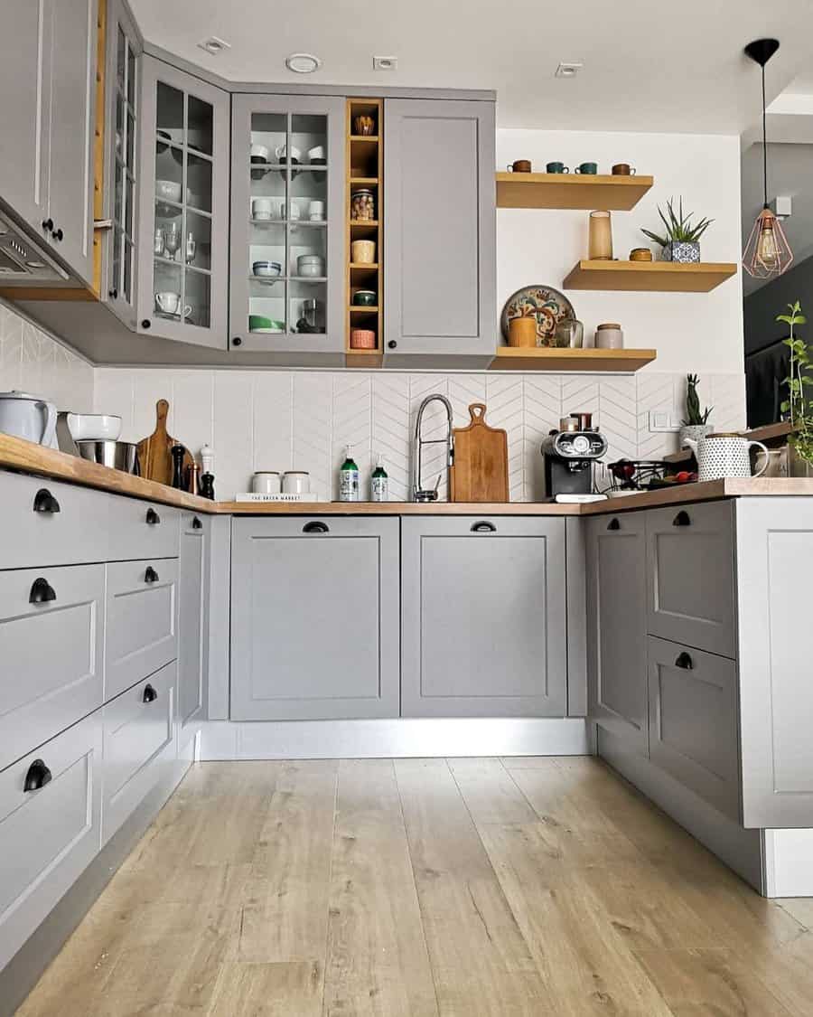 Gray Kitchen With Wood Flooring And Cabinets