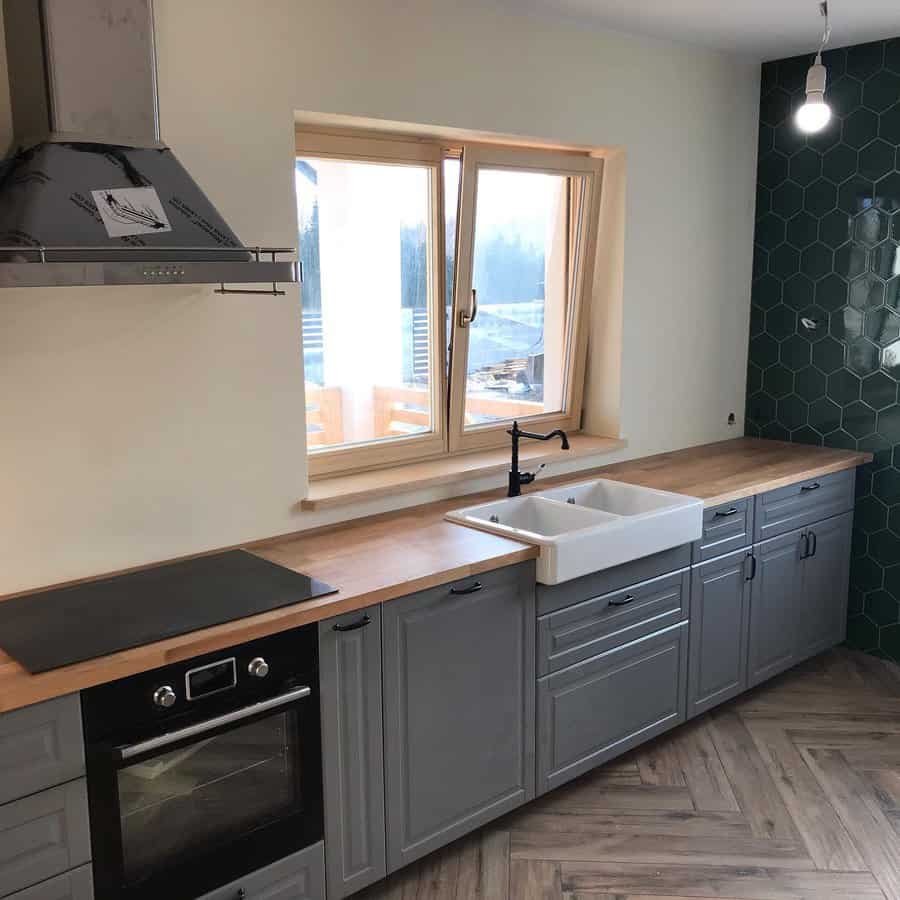 Kitchen with hexagonal tiles and wooden countertop