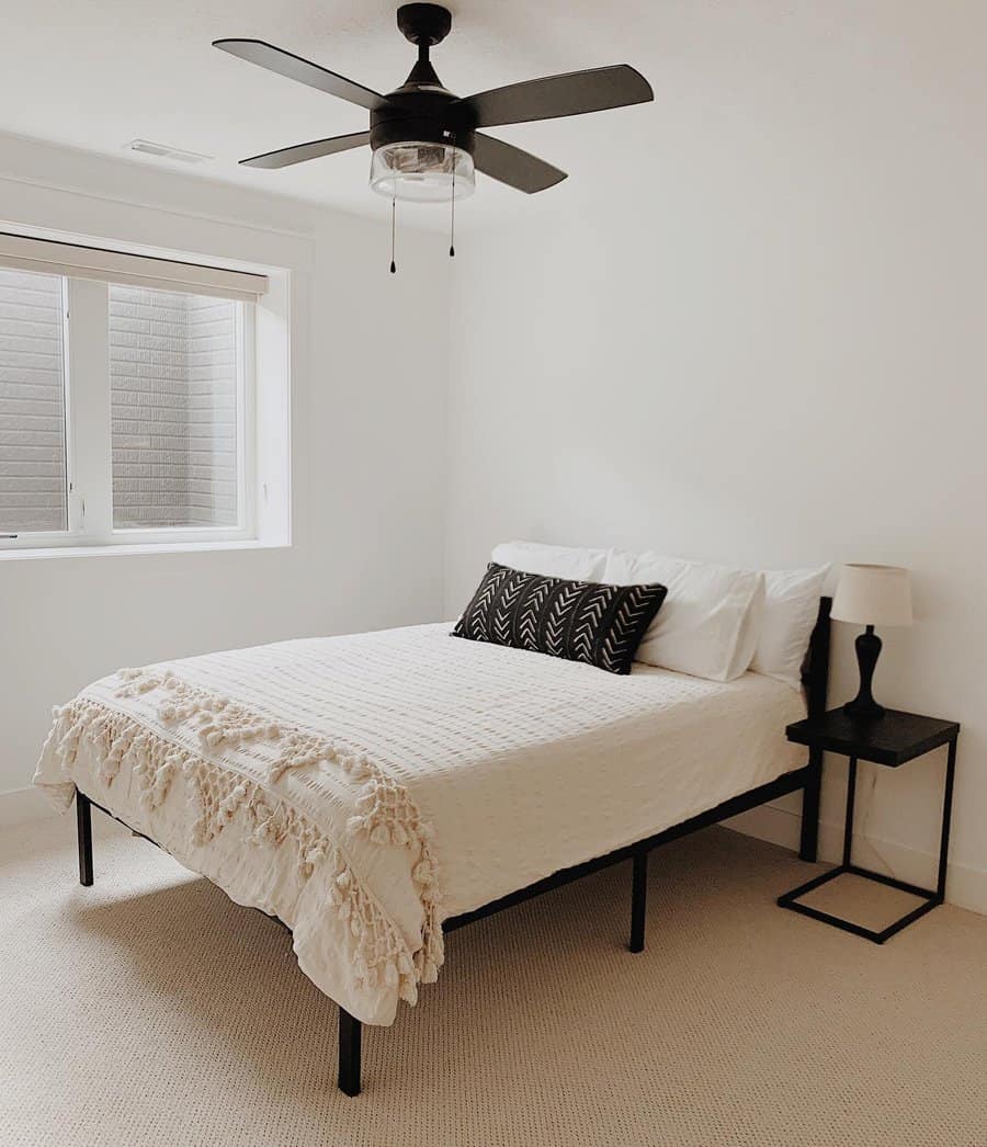 Simple bedroom with window and ceiling fan