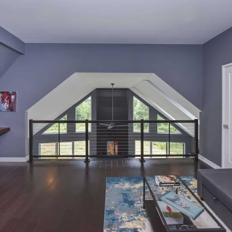 Loft area with cable railing and dark floors