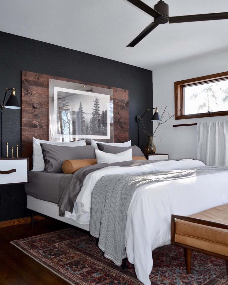 Stylish bedroom with dark accent wall and art