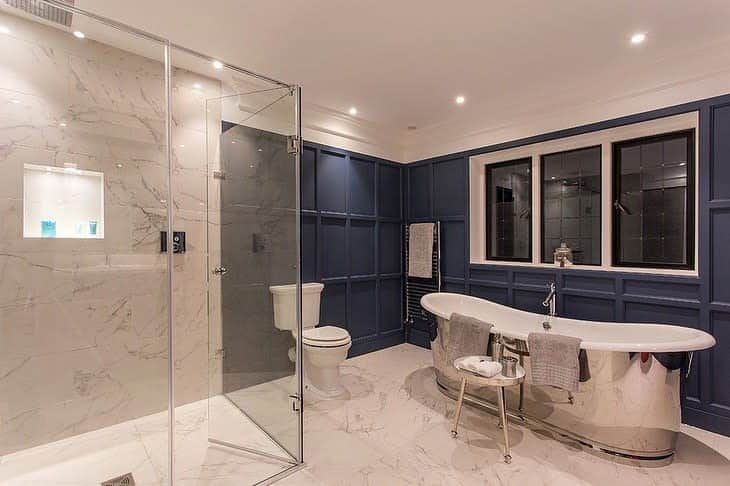 Chic bathroom with marble tiles and blue walls