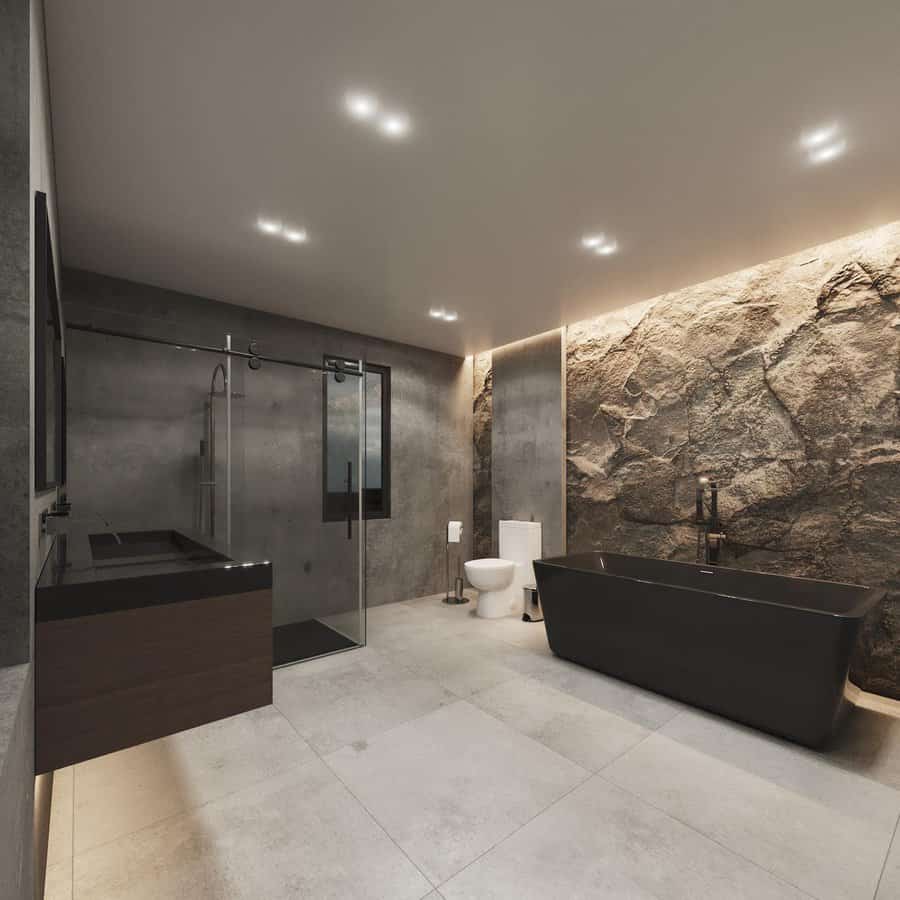 Modern bathroom with rock wall and recessed lighting