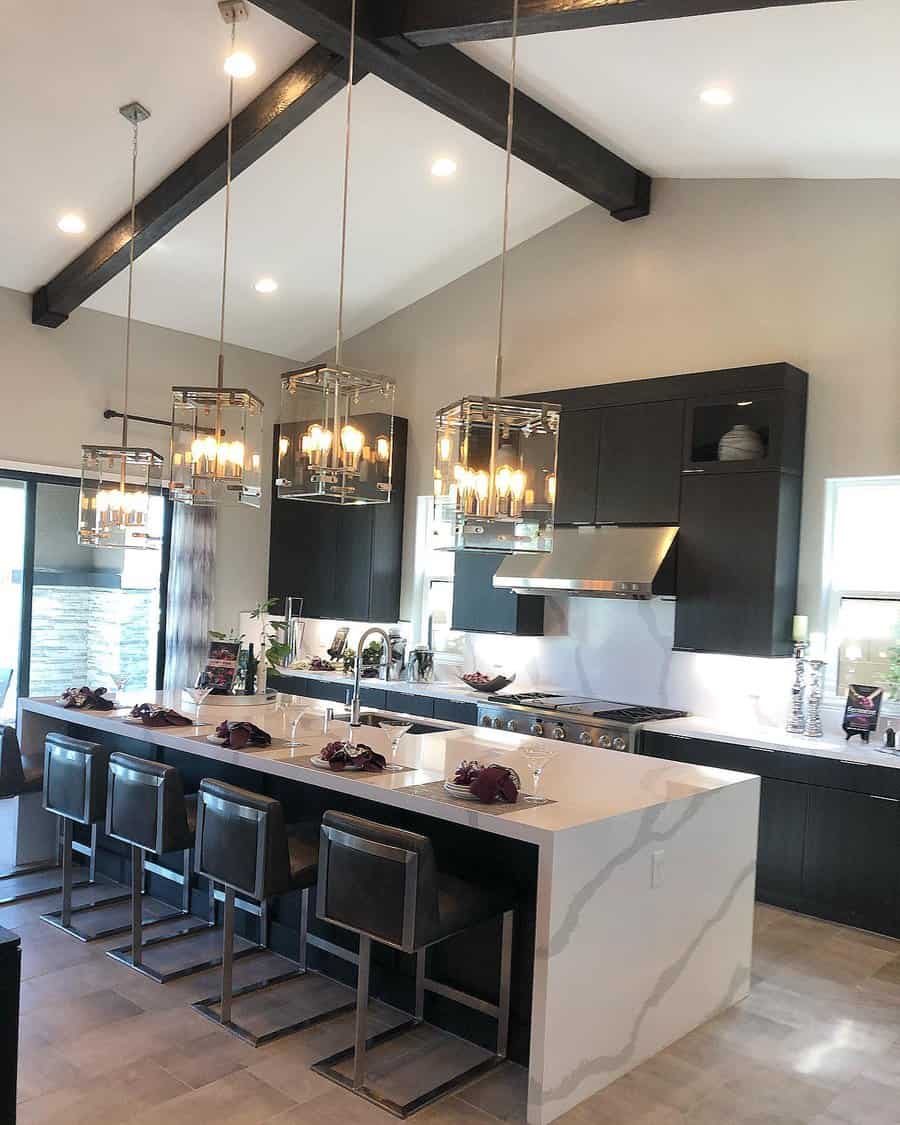 Modern kitchen with island, pendant lights, high ceilings, and dark cabinets