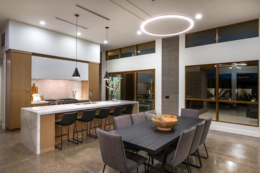 Modern kitchen and dining area with sleek furniture and pendant lighting