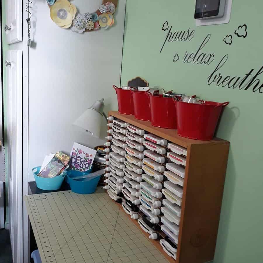 Craft room with stamp shelf and red organizers