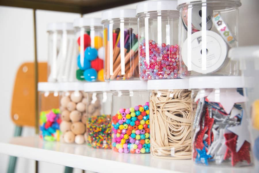 Jars of beads and craft supplies on shelf