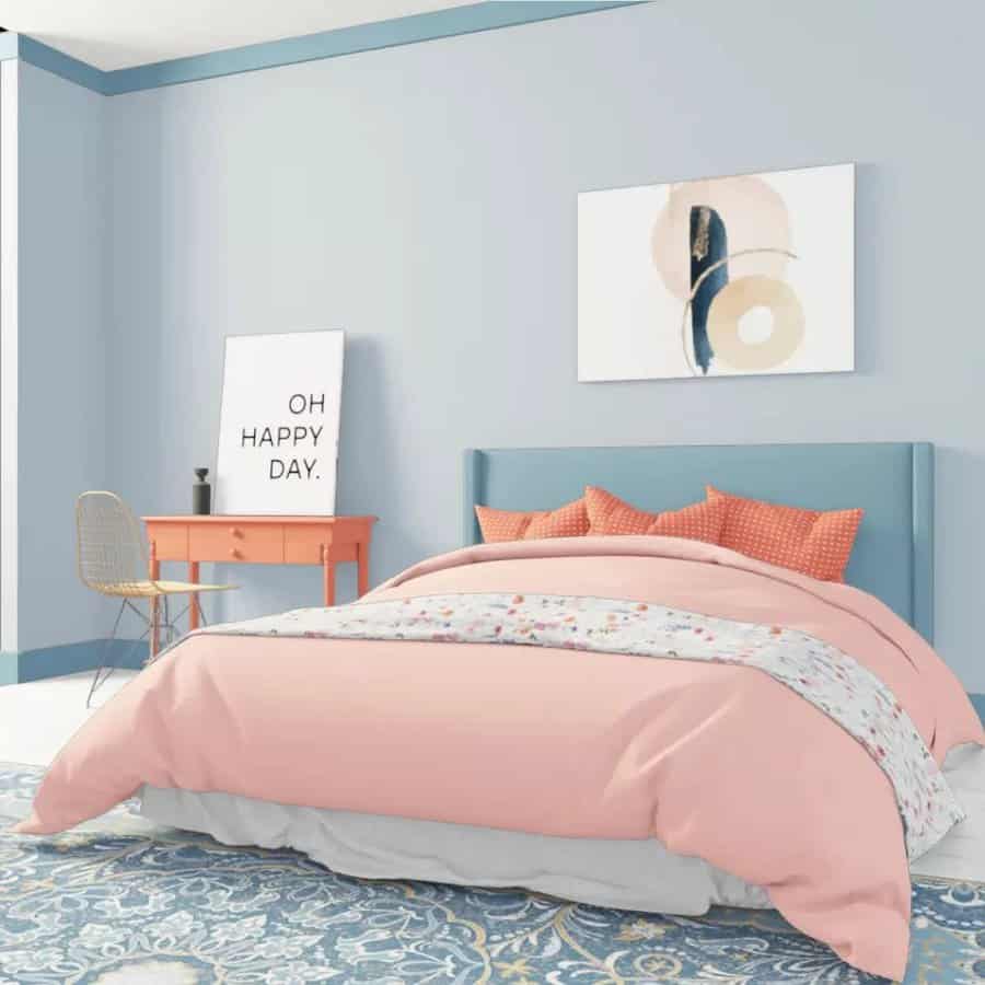 Bright bedroom with pink bedding and blue walls