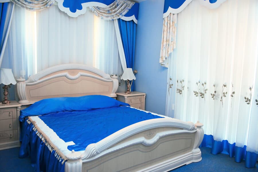 vibrant blue bedroom with blue curtain and blue beddings