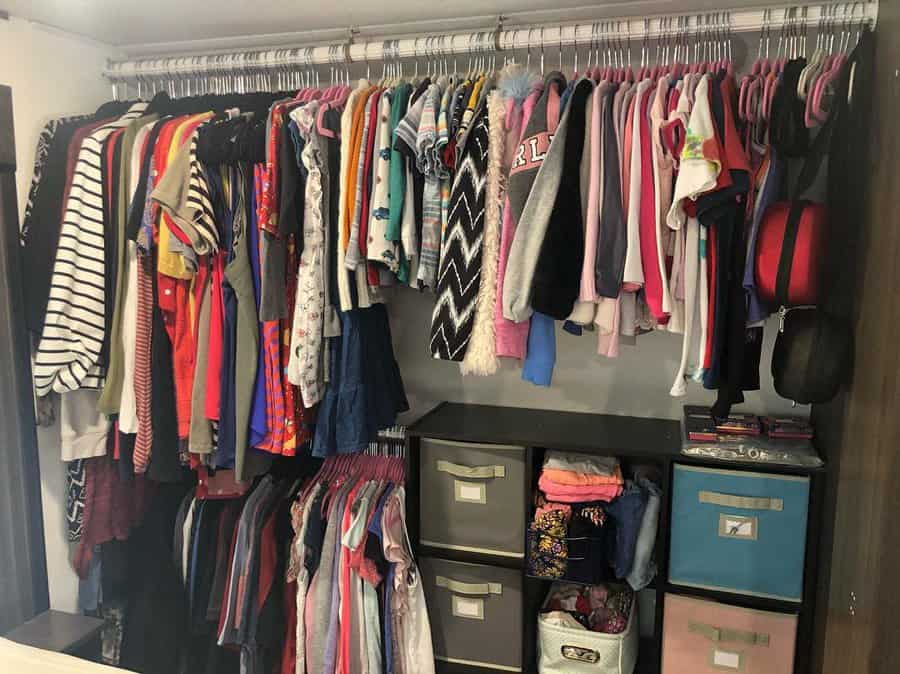 Organized RV closet with clothing and storage bins