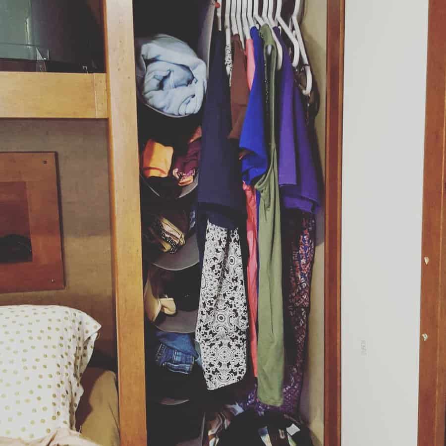 RV wardrobe with hanging clothes and additional shelving