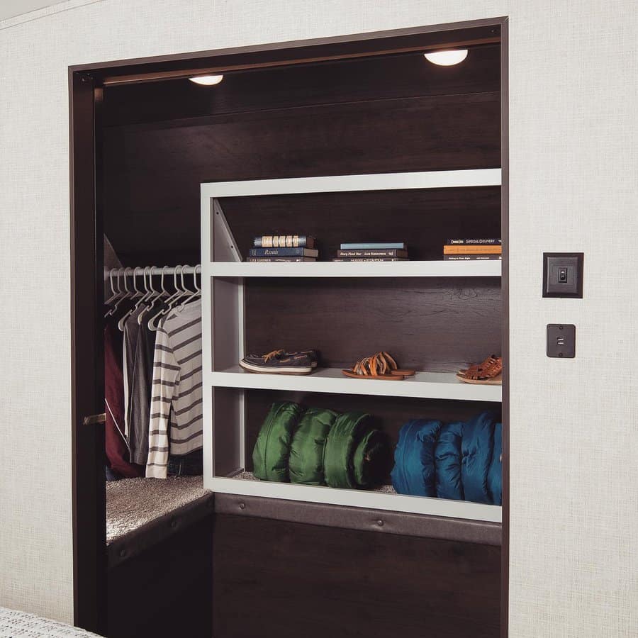 Modern RV closet with clothing rack and organized shelves