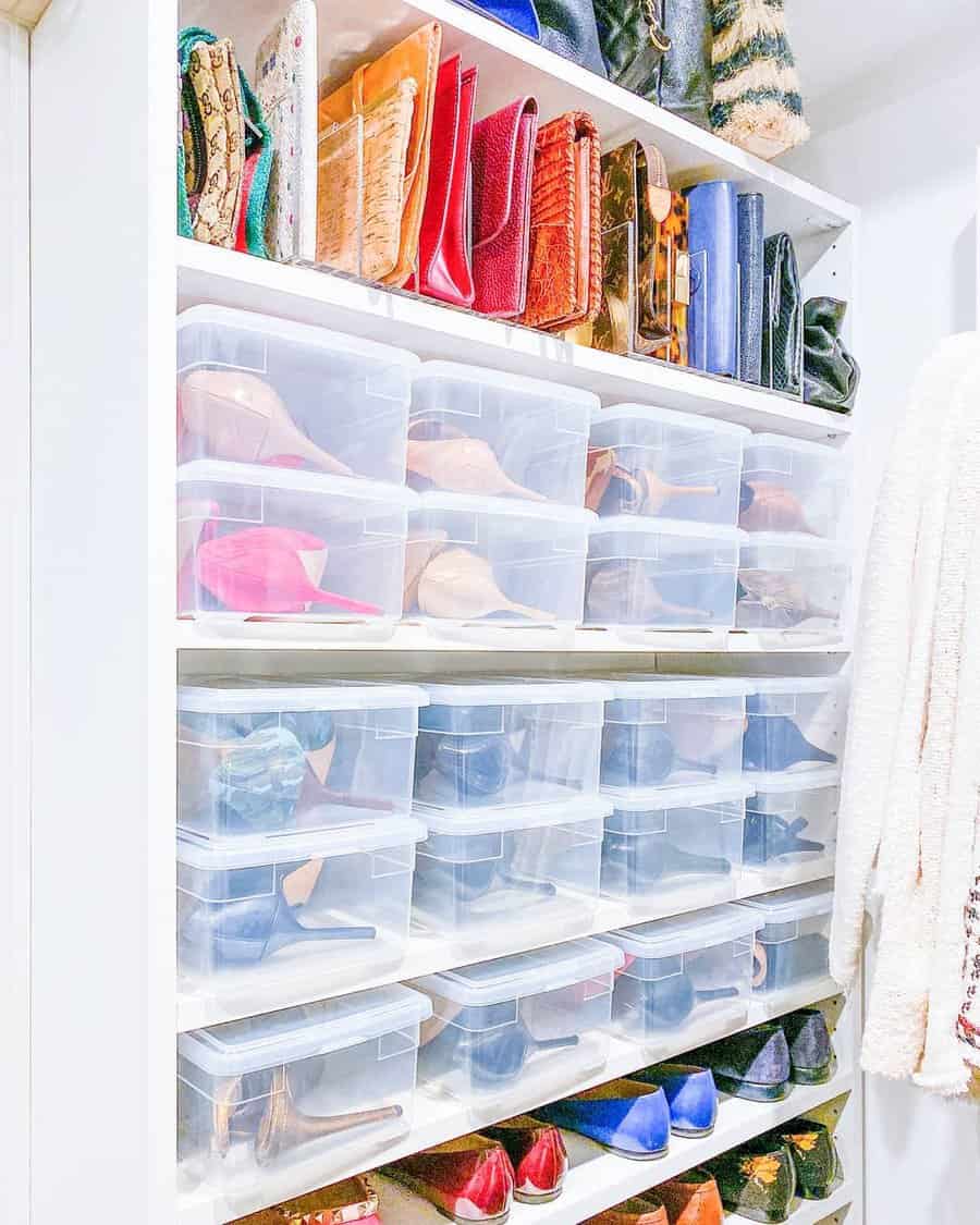 Closet shelves with organized handbags and clear boxes containing various pairs of shoes