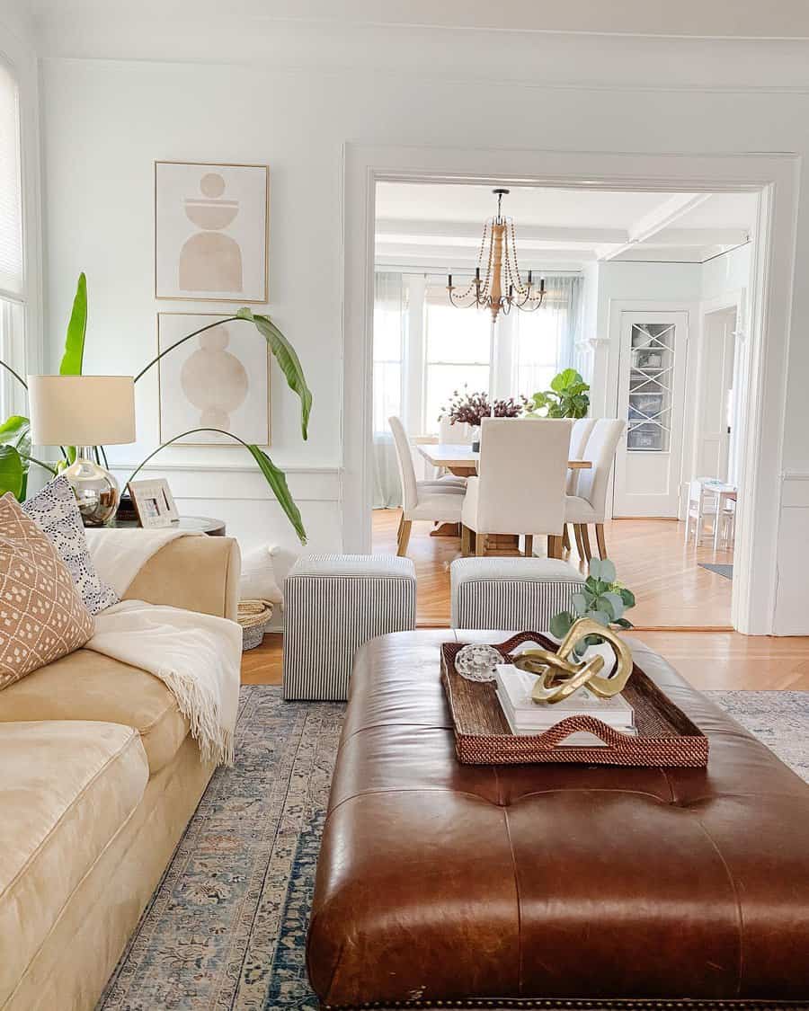 Bright living room with leather ottoman and beige sofa