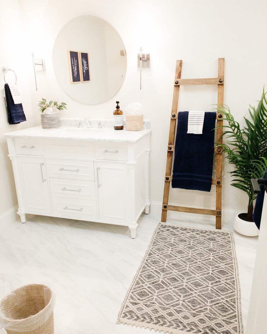 Bright bathroom with white vanity and oval mirror