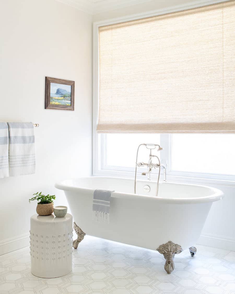 Serene bathroom with clawfoot tub and art