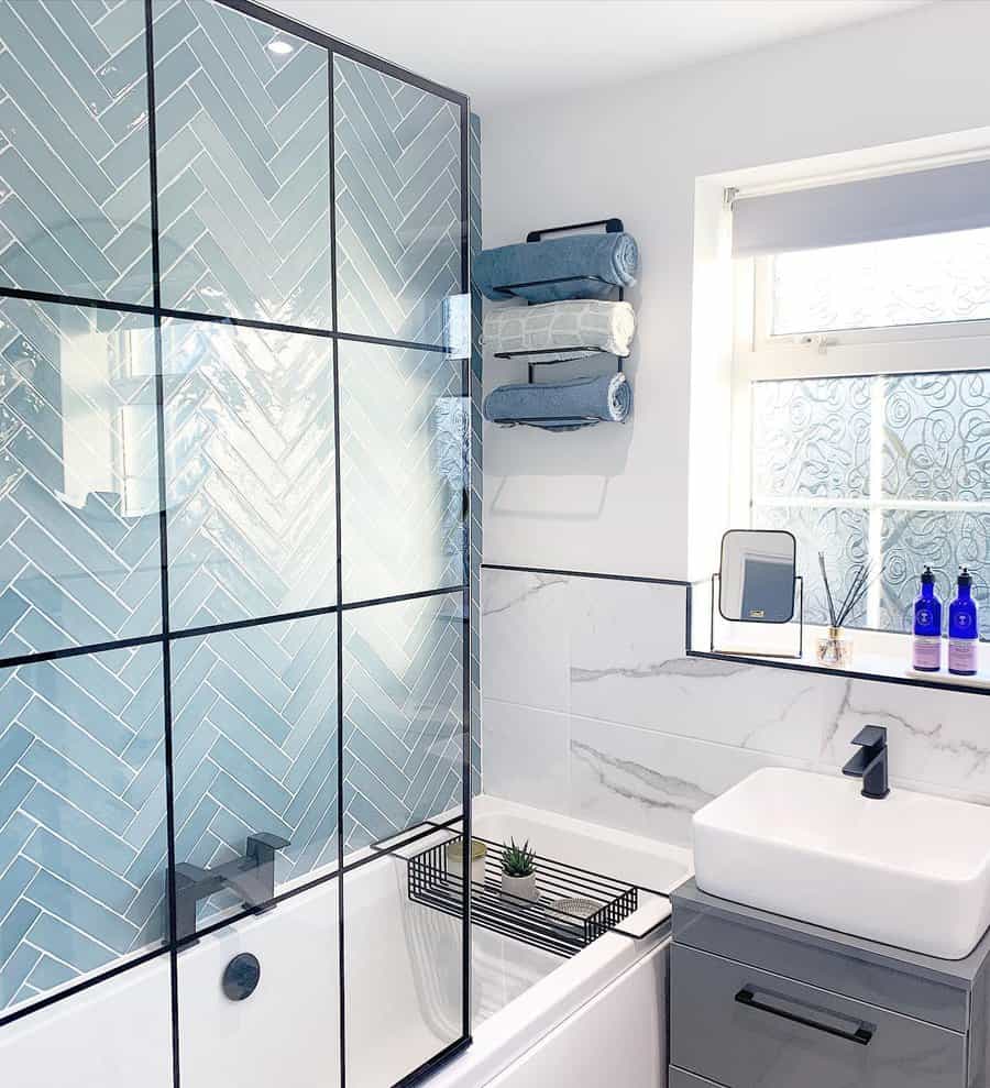 Modern bathroom with herringbone blue tiles and white sink