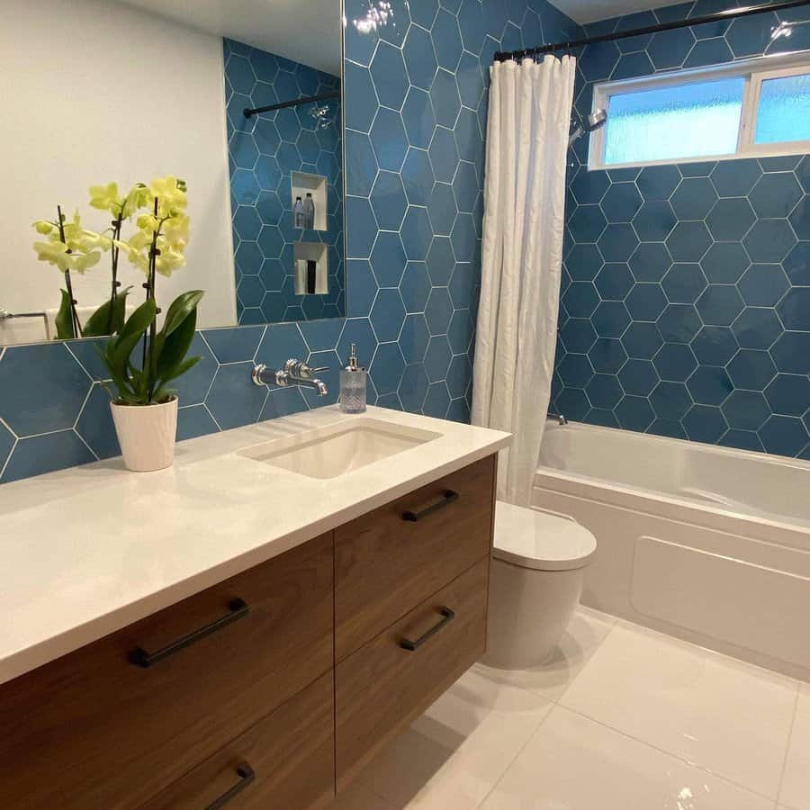 Bathroom with hexagonal blue tiles and wooden vanity