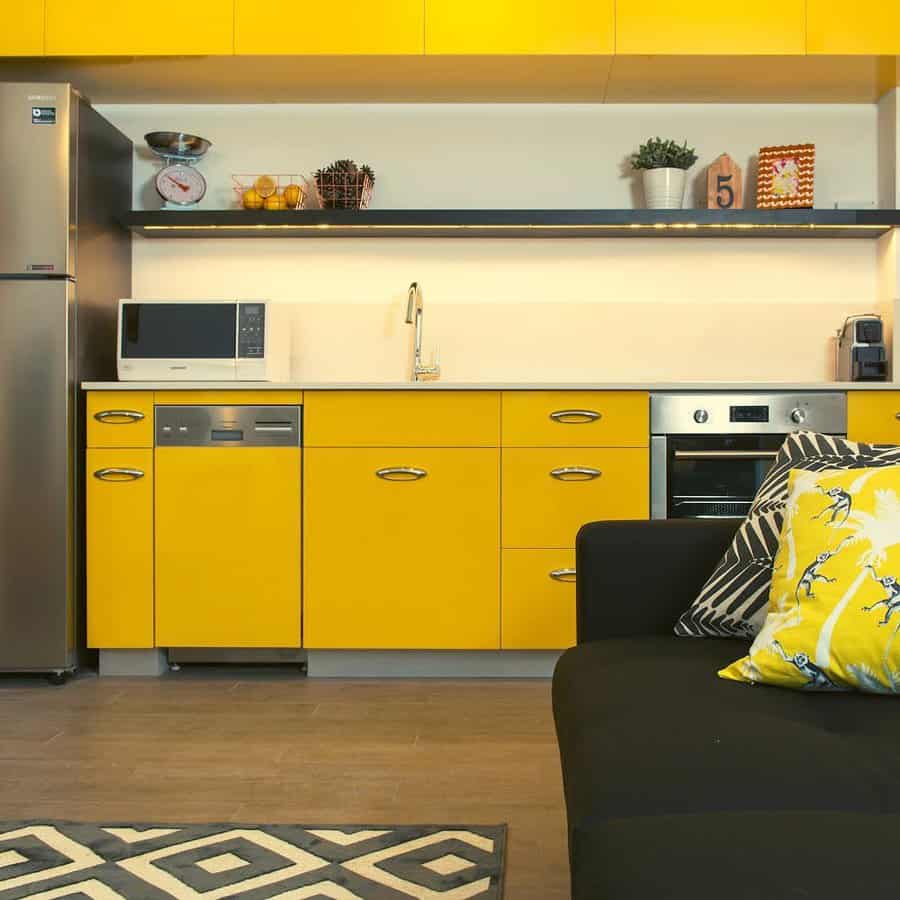 apartment kitchen with sunny yellow cabinets