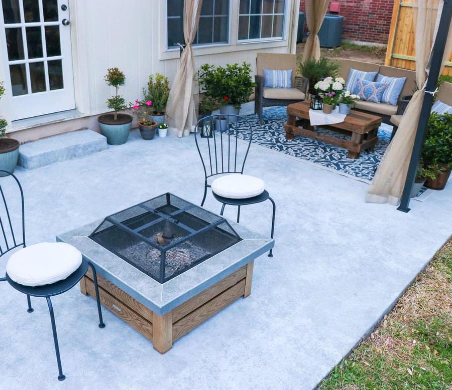 Patio with concrete and wood modern fireplace