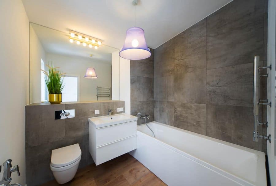 Stylish bathroom with plant and purple lamp