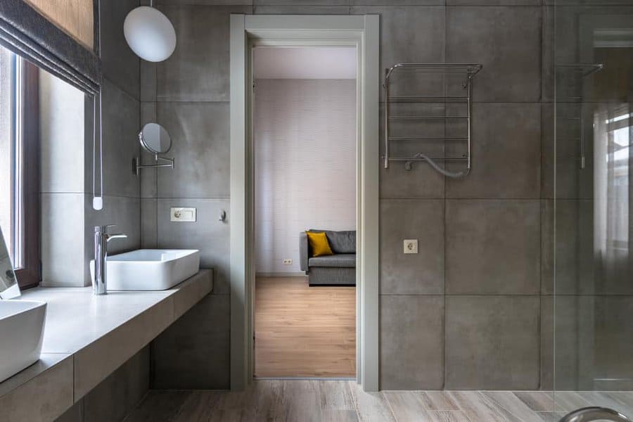 Elegant bathroom with mirror and view into bedroom