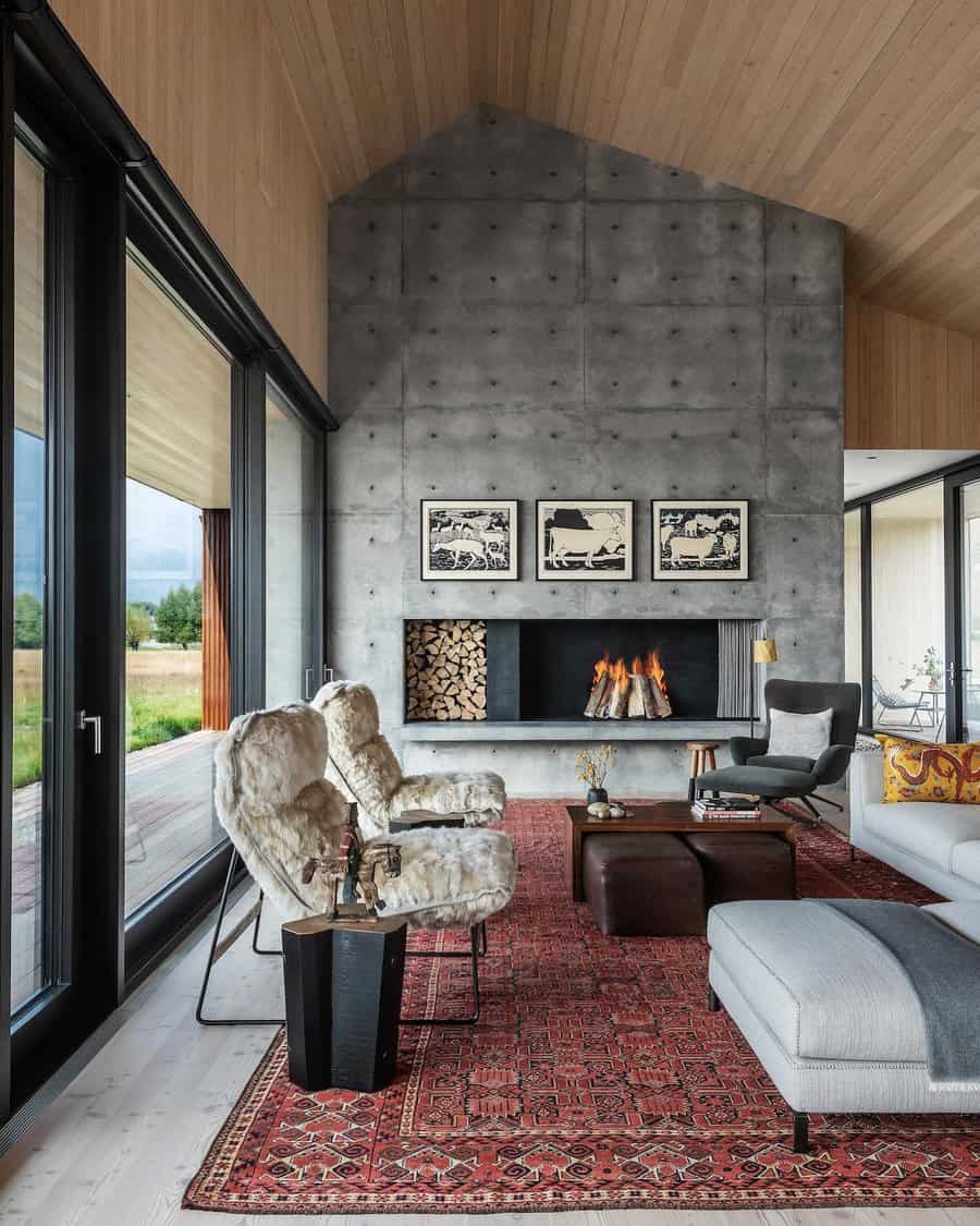 Modern living room with concrete fireplace and plush chairs