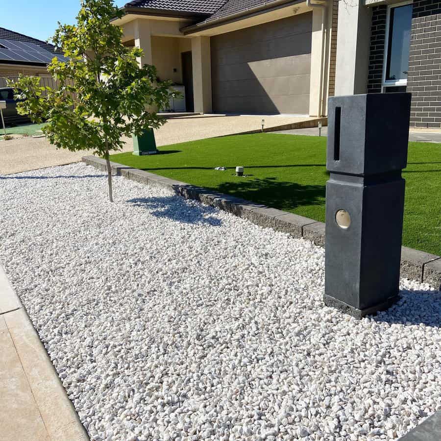 Front yard with mailbox and white stones