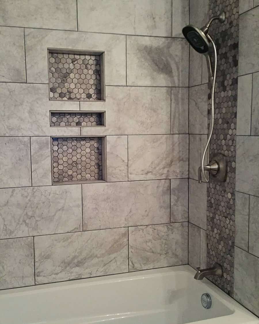 Shower area with grey tiles and pebble accents