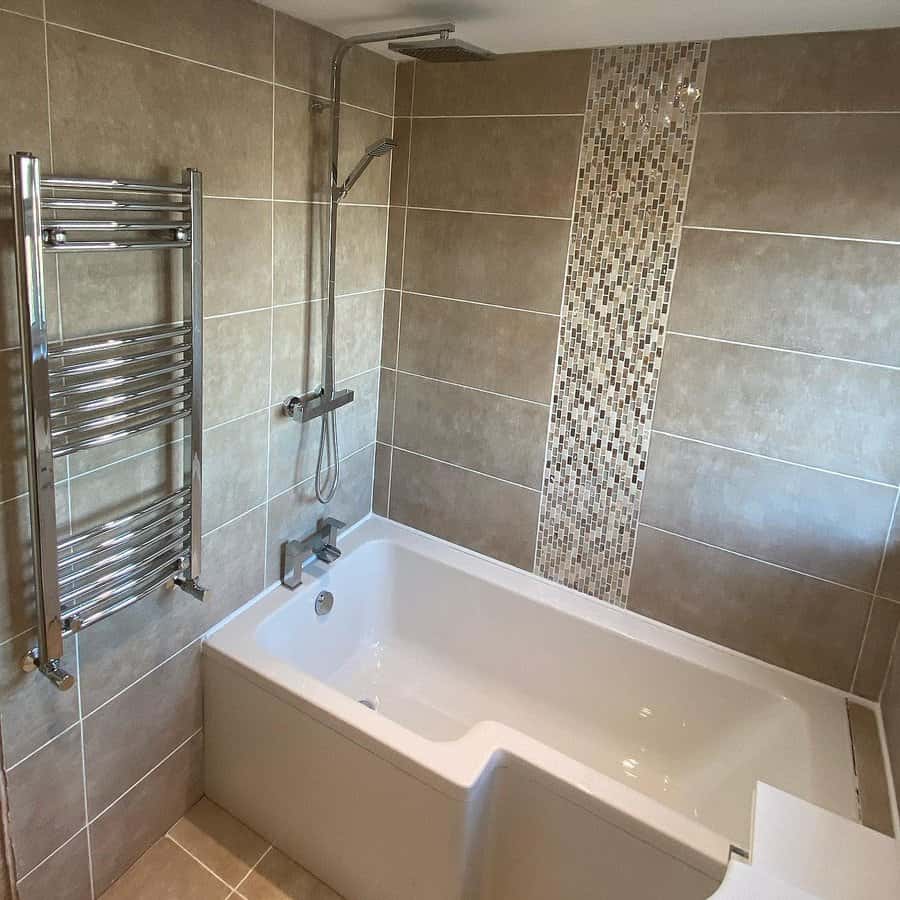 Modern bathroom with beige tiles and mosaic feature strip