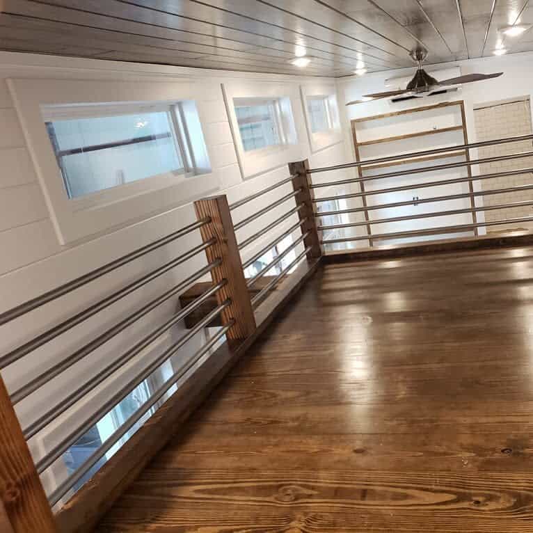 Wooden loft with horizontal cable railing