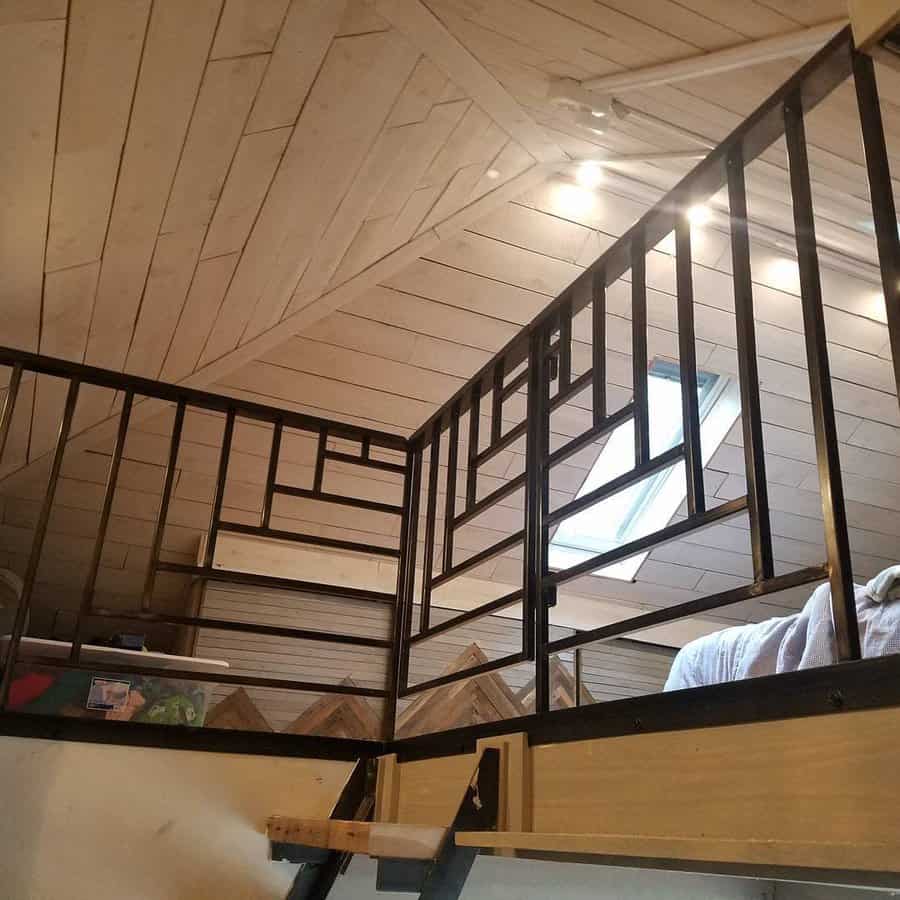 Angled view of a loft with black railing