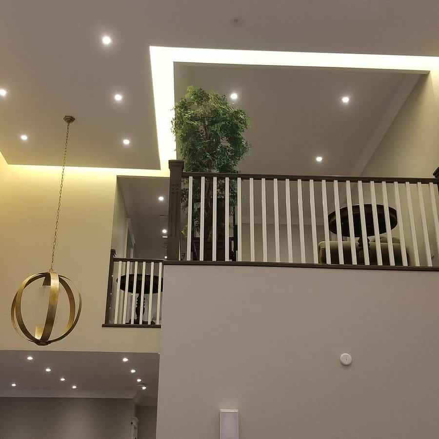 Modern loft with white railing and pendant light