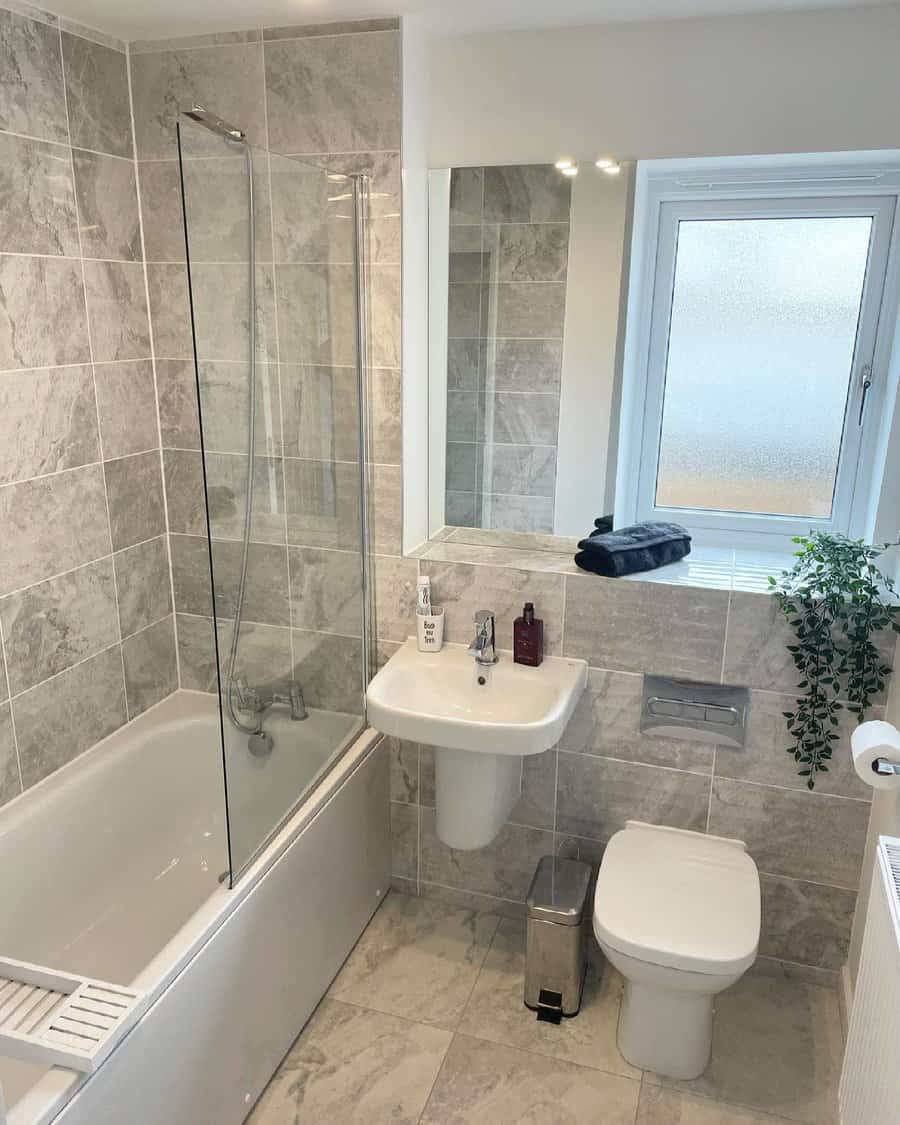 Neutral bathroom with bath and frosted window