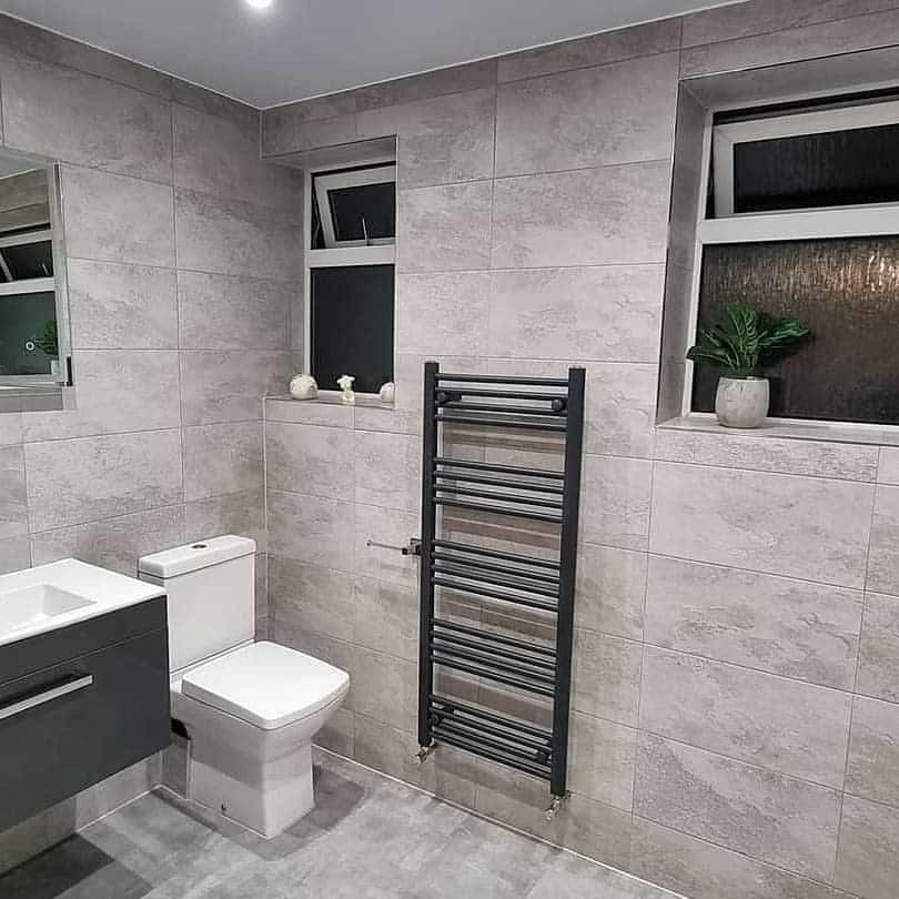 Modern gray tiled bathroom with radiator