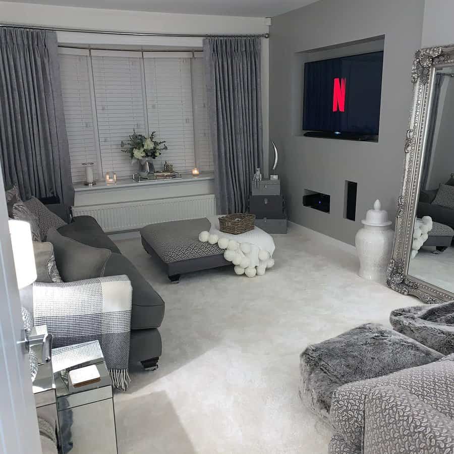 Plush gray living room with large mirror and Netflix on TV