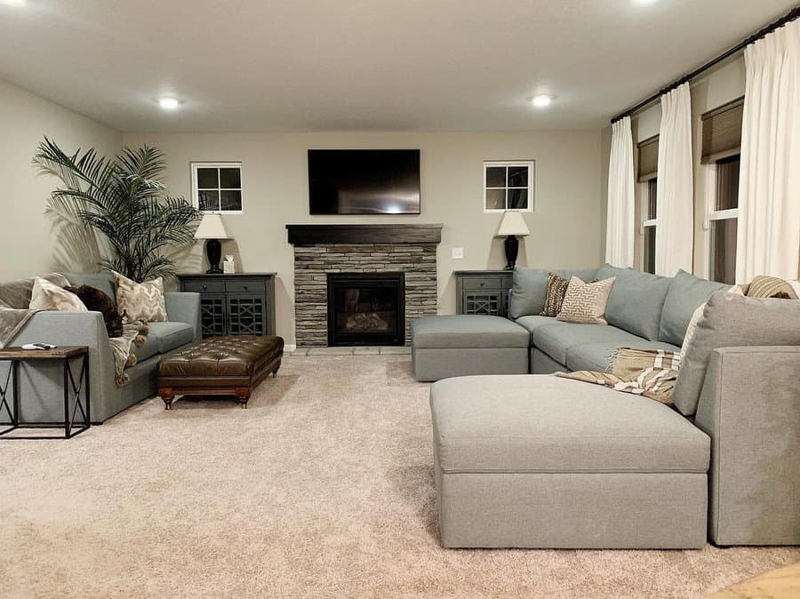 Spacious living room with sectional sofa and stone fireplace