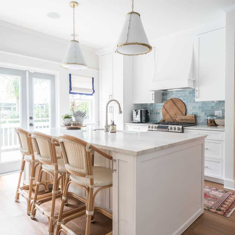 white marble kitchen island with rattan seating