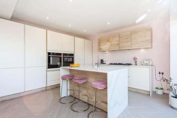 marble kitchen island with pink suede seating