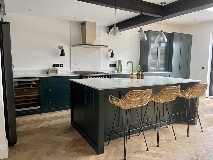 Elegant kitchen with wicker chairs and glass pendants