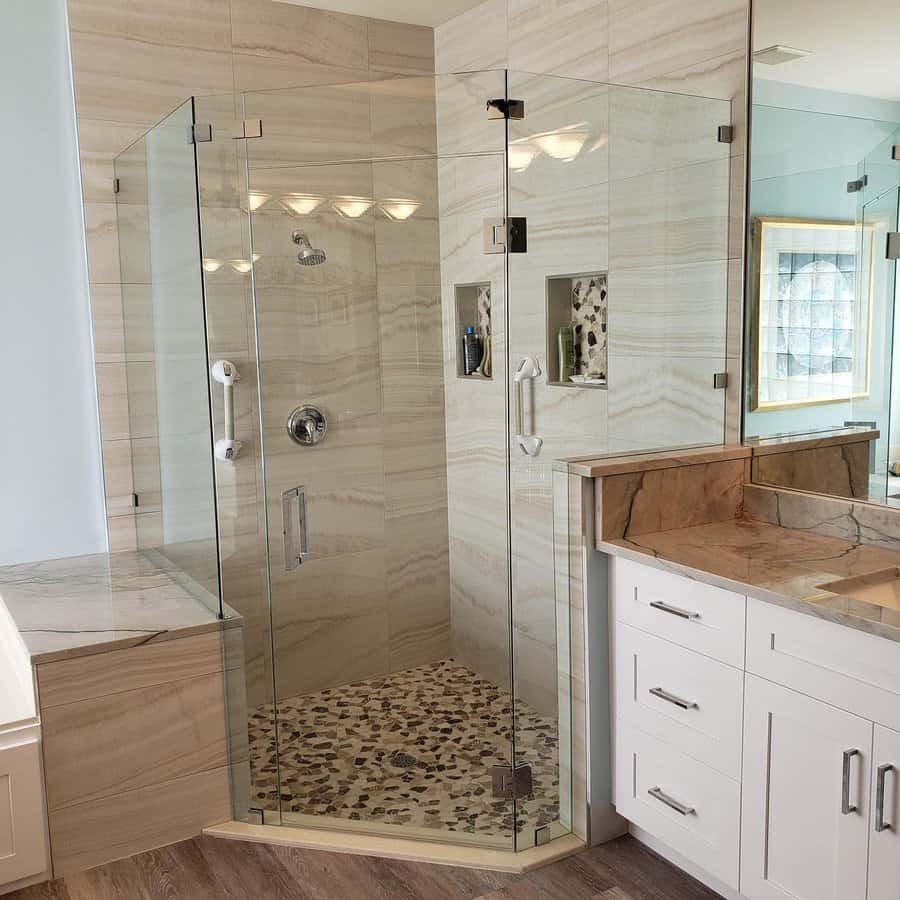 Elegant shower with stone tiles and pebble floor