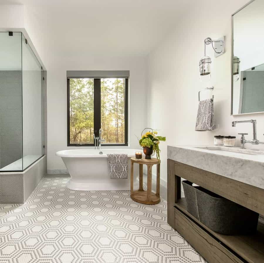 Elegant bathroom with freestanding tub and forest view