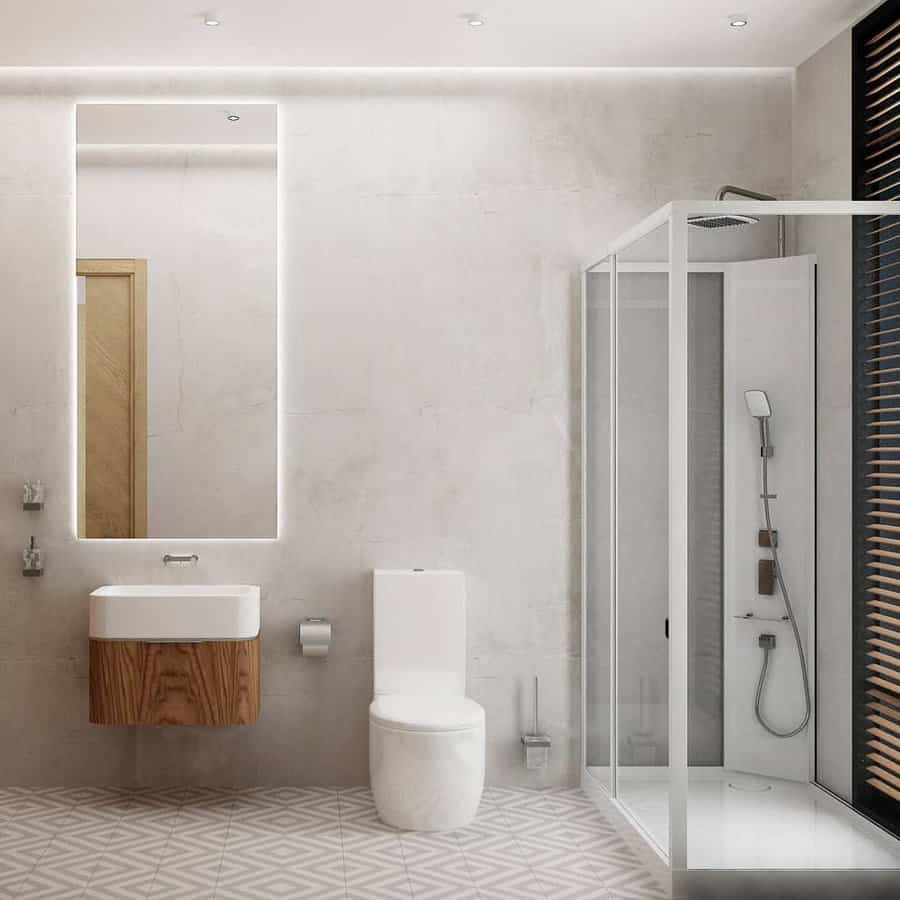 Minimalist bathroom with illuminated mirror and corner shower